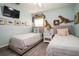 Bedroom featuring two twin beds, nautical decor, and light blue walls at 4524 106Th W St, Bradenton, FL 34210