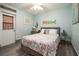Bedroom featuring bed with decorative quilt, light blue walls, wood-look floors, and nautical decor at 4524 106Th W St, Bradenton, FL 34210