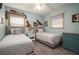Charming bedroom with twin beds, coastal decor, wood-look floors, and a serene ambiance at 4524 106Th W St, Bradenton, FL 34210