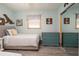 Bedroom with light blue walls, wood-look floors, full bed, and nautical decor at 4524 106Th W St, Bradenton, FL 34210