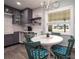 Cozy dining area featuring round table, modern light fixture, and stylishly tiled backsplash next to the kitchen at 4524 106Th W St, Bradenton, FL 34210