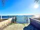 Picturesque waterfront view featuring a private dock with clear blue sky and sunlit waters at 4524 106Th W St, Bradenton, FL 34210