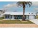 Charming home with well-manicured lawn, metal roof, and inviting front porch offering delightful curb appeal at 4524 106Th W St, Bradenton, FL 34210