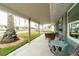 Inviting front porch with comfortable seating, offering a relaxing outdoor space and partial water view at 4524 106Th W St, Bradenton, FL 34210