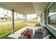 Relaxing front porch with comfortable outdoor seating, perfect for enjoying the serene neighborhood view at 4524 106Th W St, Bradenton, FL 34210
