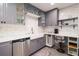 Stylish kitchen with gray cabinetry, farmhouse sink, stainless steel appliances, and modern fixtures at 4524 106Th W St, Bradenton, FL 34210