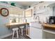 Bright kitchen with breakfast bar, farmhouse sink, open shelving and natural light at 4524 106Th W St, Bradenton, FL 34210