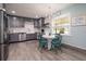 Stylish kitchen with gray cabinetry, stainless steel appliances, and adjacent dining area with charming decor at 4524 106Th W St, Bradenton, FL 34210