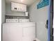 Functional laundry room with washer, dryer, storage cabinets, and shelving at 4524 106Th W St, Bradenton, FL 34210
