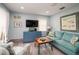 Cozy living room with blue walls, wood floors, television, and comfortable seating at 4524 106Th W St, Bradenton, FL 34210