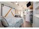 Cozy living space with queen-size bed, sleeper sofa, and kitchenette featuring a barn door and light, coastal ambiance at 4524 106Th W St, Bradenton, FL 34210