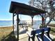 Inviting outdoor seating area features a gazebo with swing benches and park benches for enjoying water views at 4524 106Th W St, Bradenton, FL 34210