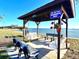 Charming outdoor seating area offers swing benches and park benches to enjoy the beautiful waterfront views at 4524 106Th W St, Bradenton, FL 34210