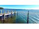 Waterfront property featuring a private pier extending into the clear blue water, offering scenic views at 4524 106Th W St, Bradenton, FL 34210