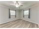 Cozy bedroom with hardwood floors, a ceiling fan, and natural light from two windows at 4550 Ardale St, Sarasota, FL 34232