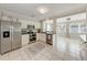 Bright and modern kitchen with stainless steel appliances, white cabinetry, and an adjacent dining area at 4550 Ardale St, Sarasota, FL 34232