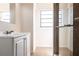 The bathroom has a shower with glass doors and a vanity sink for a convenient space at 4659 Alligator Dr, Venice, FL 34293