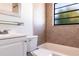 The bathroom features ceramic tiling and vanity sink for your everyday needs at 4659 Alligator Dr, Venice, FL 34293