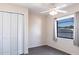 This bedroom features wood look floors, a ceiling fan, closet and large window at 4659 Alligator Dr, Venice, FL 34293