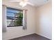 A bedroom window with curtains offering natural light and backyard view at 4659 Alligator Dr, Venice, FL 34293