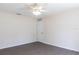 A simple bedroom with a ceiling fan and door offers a blank canvas for personalization at 4659 Alligator Dr, Venice, FL 34293