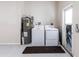 This laundry area contains a washer, dryer and a water heater at 4659 Alligator Dr, Venice, FL 34293