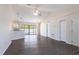 Spacious open-concept living area with modern ceiling fans, beautiful laminate flooring, and lots of natural light at 4659 Alligator Dr, Venice, FL 34293