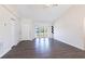 Bright living room featuring elegant laminate flooring, ample natural light, and soaring high ceilings for an airy feel at 4659 Alligator Dr, Venice, FL 34293
