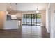 Bright living space that flows to screened lanai, featuring pendant lighting, and white cabinetry with granite countertops at 4659 Alligator Dr, Venice, FL 34293