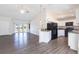 Inviting open-concept, with laminate flooring, connecting the kitchen and living area for easy entertaining and everyday living at 4659 Alligator Dr, Venice, FL 34293