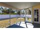 View of the screened porch with outdoor access to the backyard and a doorway to the house at 4659 Alligator Dr, Venice, FL 34293