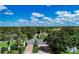 Aerial view of the community entrance, lush landscaping, and the surrounding green landscape at 5 Barbados Rd # 31, Englewood, FL 34223