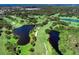 Beautiful golf course aerial featuring scenic water hazards, mature trees, and meticulously maintained fairways at 5 Barbados Rd # 31, Englewood, FL 34223