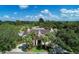 Stunning aerial view of an estate with meticulous landscaping, circular driveway, and a lush green surrounding at 5 Barbados Rd # 31, Englewood, FL 34223