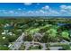 Expansive aerial view of a golf course community featuring lush green fairways, serene lakes, and beautiful landscaping at 5 Barbados Rd # 31, Englewood, FL 34223