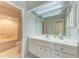 Bright bathroom with a white vanity, a large mirror, and a tiled tub-shower combination at 5 Barbados Rd # 31, Englewood, FL 34223