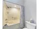 A full bathroom featuring a tile shower-tub with a rainfall shower head and a patterned shower curtain at 5 Barbados Rd # 31, Englewood, FL 34223