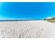Wide angle of sandy beach view with blue sky provides a picturesque setting for relaxation and recreation at 5 Barbados Rd # 31, Englewood, FL 34223