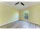 Bedroom with modern flooring and a bright, airy window overlooking greenery at 5 Barbados Rd # 31, Englewood, FL 34223