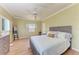 Comfortable bedroom features a ceiling fan, wood floors, and natural light at 5 Barbados Rd # 31, Englewood, FL 34223
