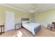 Relaxing bedroom with light green walls, wood floors, and a ceiling fan at 5 Barbados Rd # 31, Englewood, FL 34223