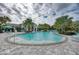 Beautiful community pool with seating and lush landscaping, perfect for leisure and recreation at 5 Barbados Rd # 31, Englewood, FL 34223