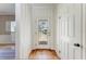Bright foyer with hardwood floors, striped wallpaper, and a clear view of the front yard at 5 Barbados Rd # 31, Englewood, FL 34223