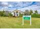 Lush landscaping and colorful flowers frame the entrance to this elegant Boca Royale Resort home at 5 Barbados Rd # 31, Englewood, FL 34223