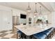 Modern kitchen with a large island, stainless steel appliances, and elegant pendant lighting at 5 Barbados Rd # 31, Englewood, FL 34223