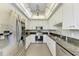 Bright kitchen featuring white cabinets, stainless steel appliances, and granite countertops at 5 Barbados Rd # 31, Englewood, FL 34223