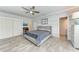 A main bedroom featuring a ceiling fan, stylish wood-look flooring, and access to the main bathroom at 5 Barbados Rd # 31, Englewood, FL 34223