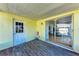 Covered patio with an exterior door and sliding glass door entry into the home at 5 Barbados Rd # 31, Englewood, FL 34223