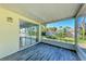 Enclosed patio with wooden floors and screen windows, offering garden views at 5 Barbados Rd # 31, Englewood, FL 34223