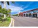 Picturesque street view of commercial buildings, lush greenery, and well-maintained sidewalks at 5 Barbados Rd # 31, Englewood, FL 34223